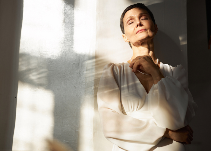 Woman pausing in quiet reflection while practicing emotional awareness